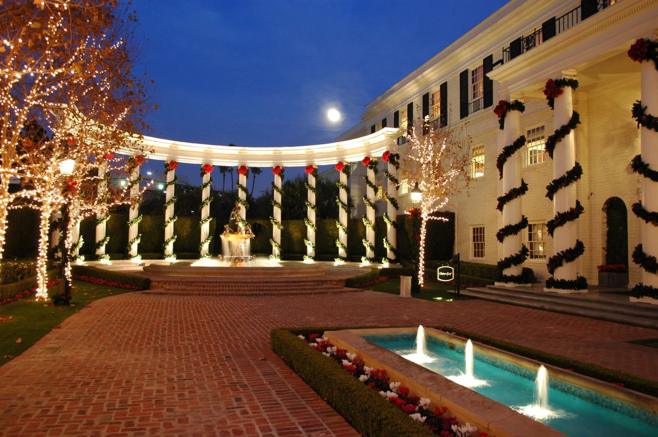 Courtyard lit with garlands at dusk